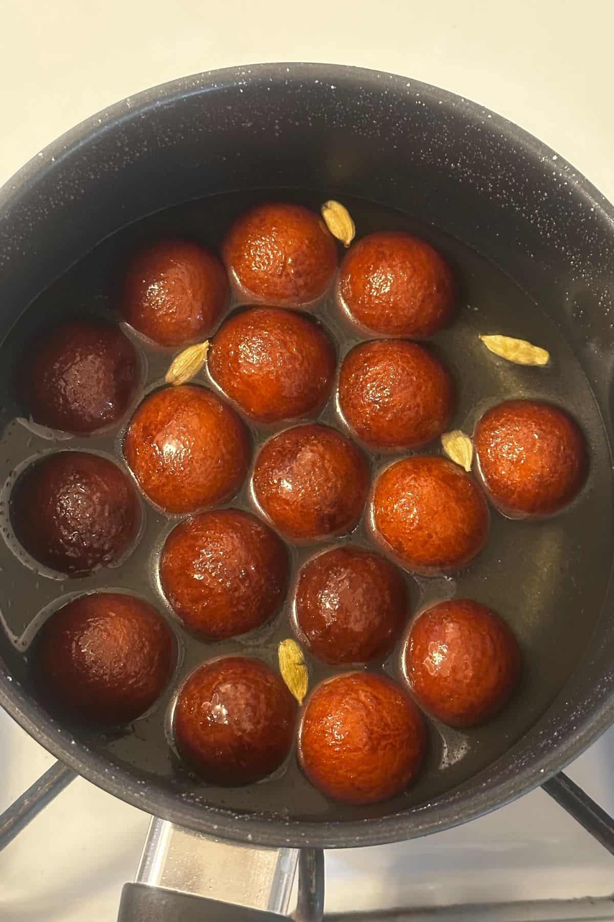 Gulab jamun are soaking in warm sugar syrup.