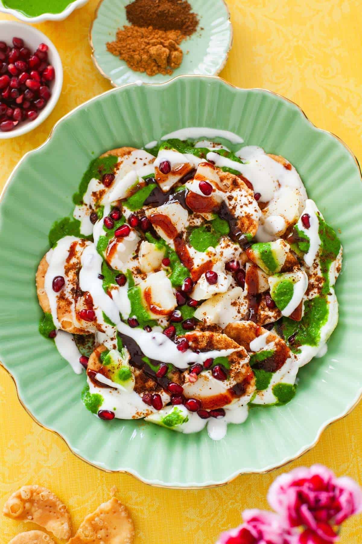 Close up of papdi chaat in a green serving bowl.