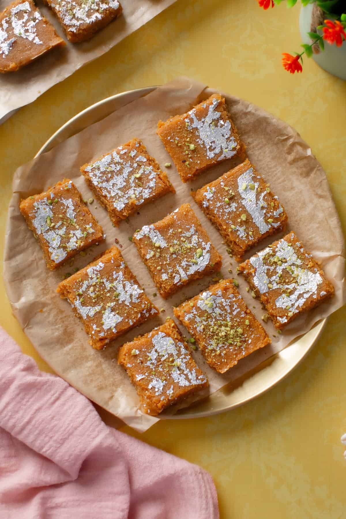 IMG_0513 Coconut burfi made with dulce de leche placed on a gold plate.