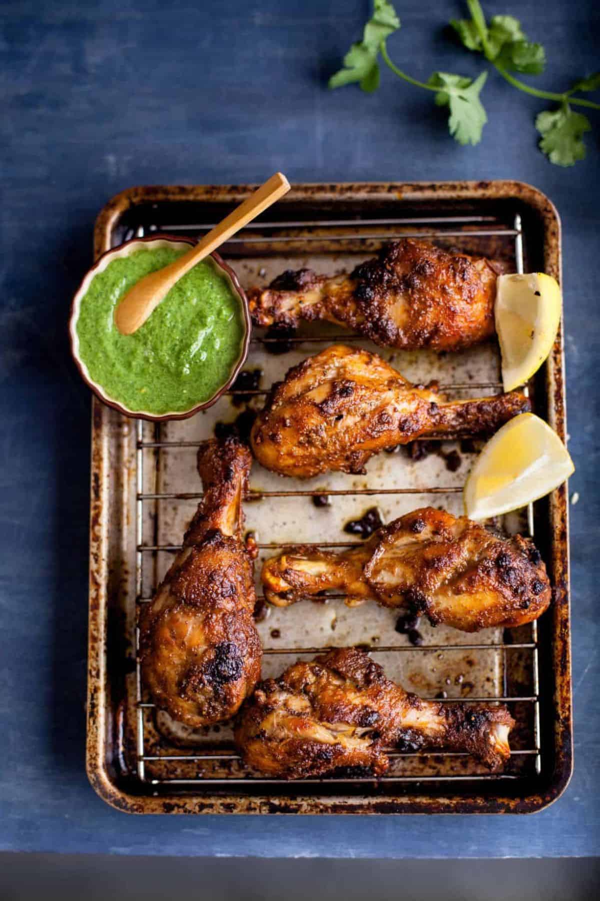 Chicken tandoori drums placed on wire rack.