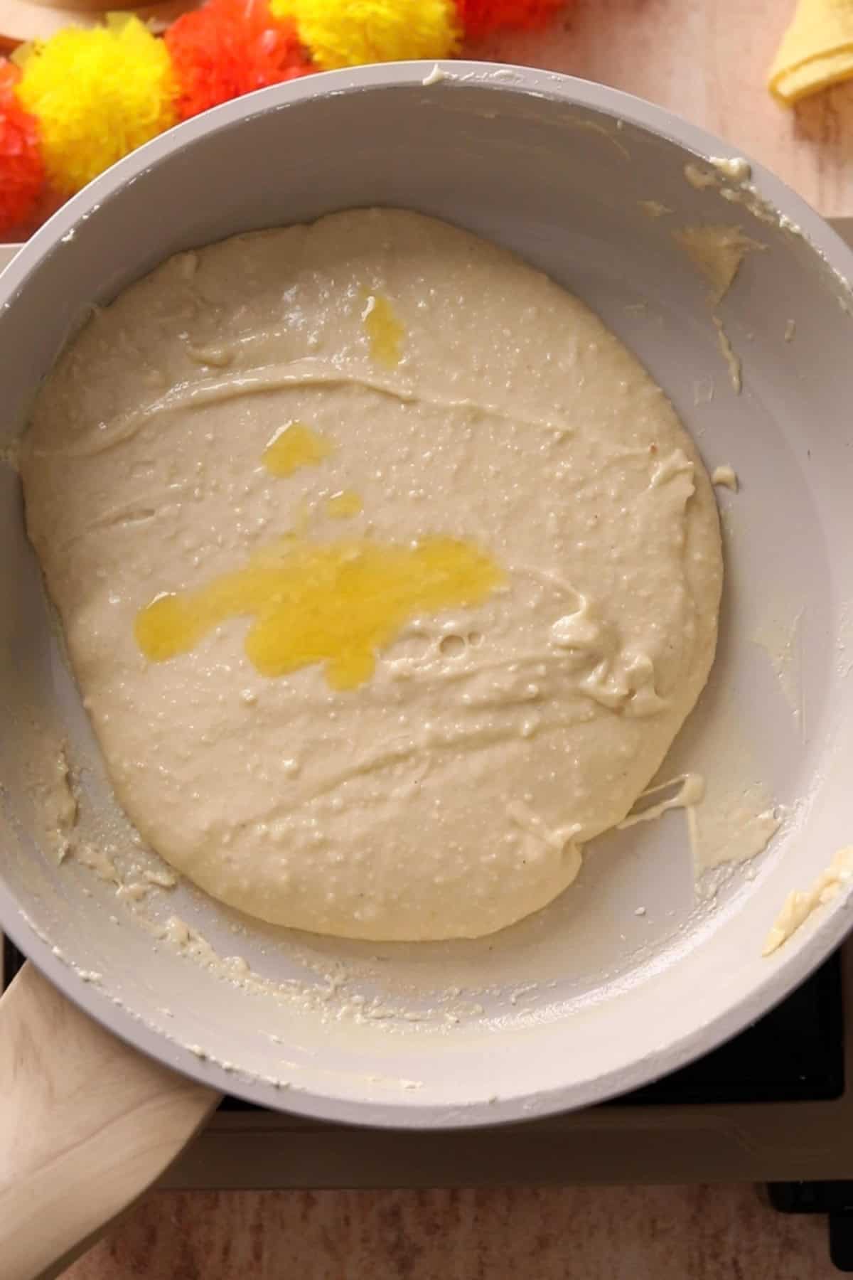 Ghee is added to the kaju katli mixture.