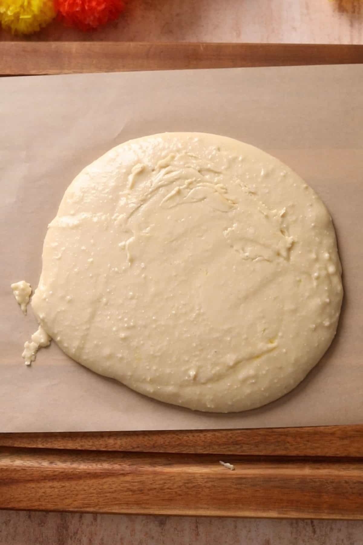 Cooked cashew dough is placed on an unbleached parchment paper.