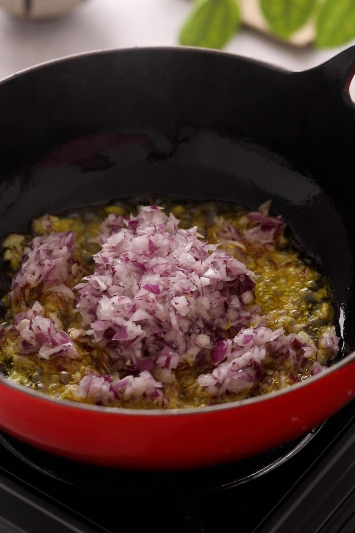 Chopped onions are added to the oil and spices.