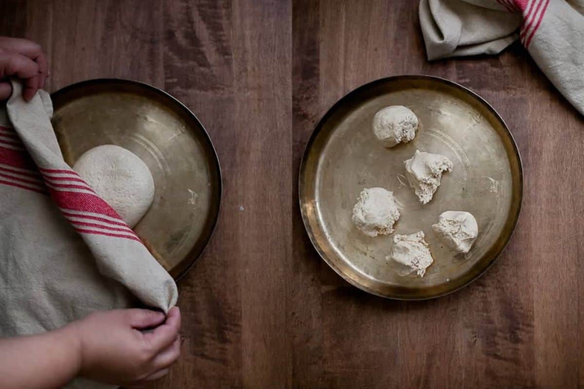 Two side-by-side images show roti dough on a brass plate. On the left, hands cover roti dough resting covered with a cloth. On right, the dough ball is divided into four pieces, with the cloth set aside at the top of the plate.