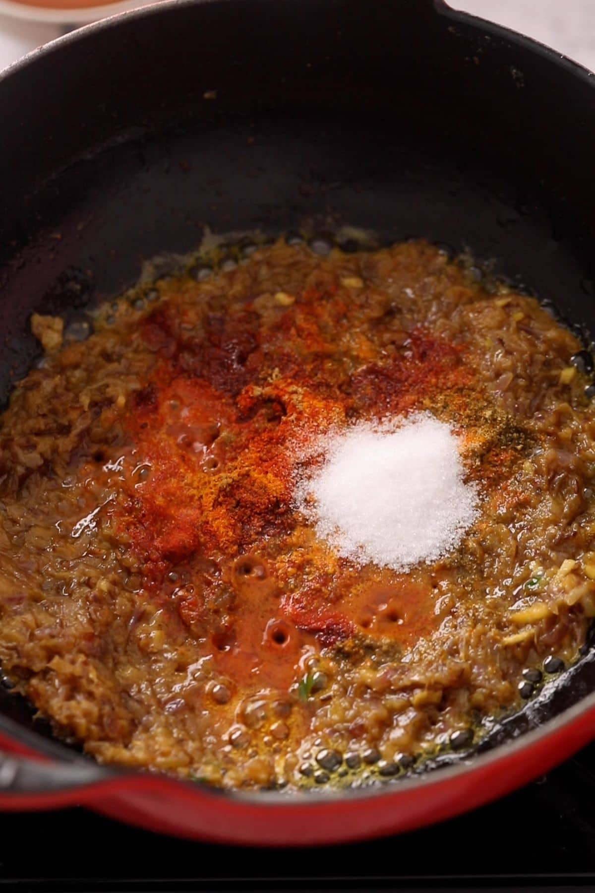 Ground spices are added to the masala.