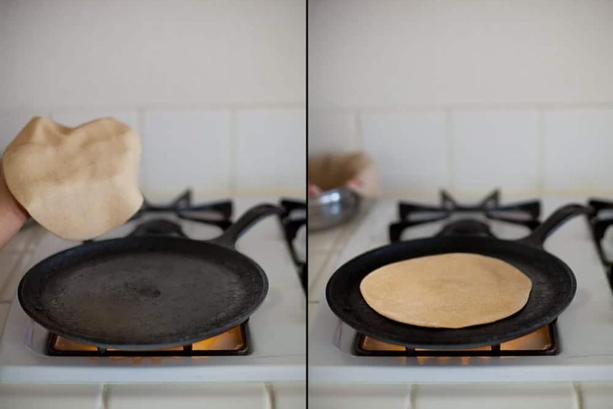 Roti is being place on a hot tawa.