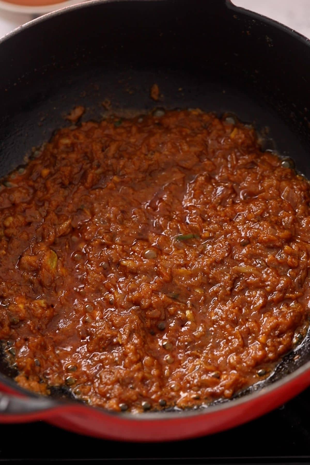 Ground spices are sautted until oil bubbles appear.