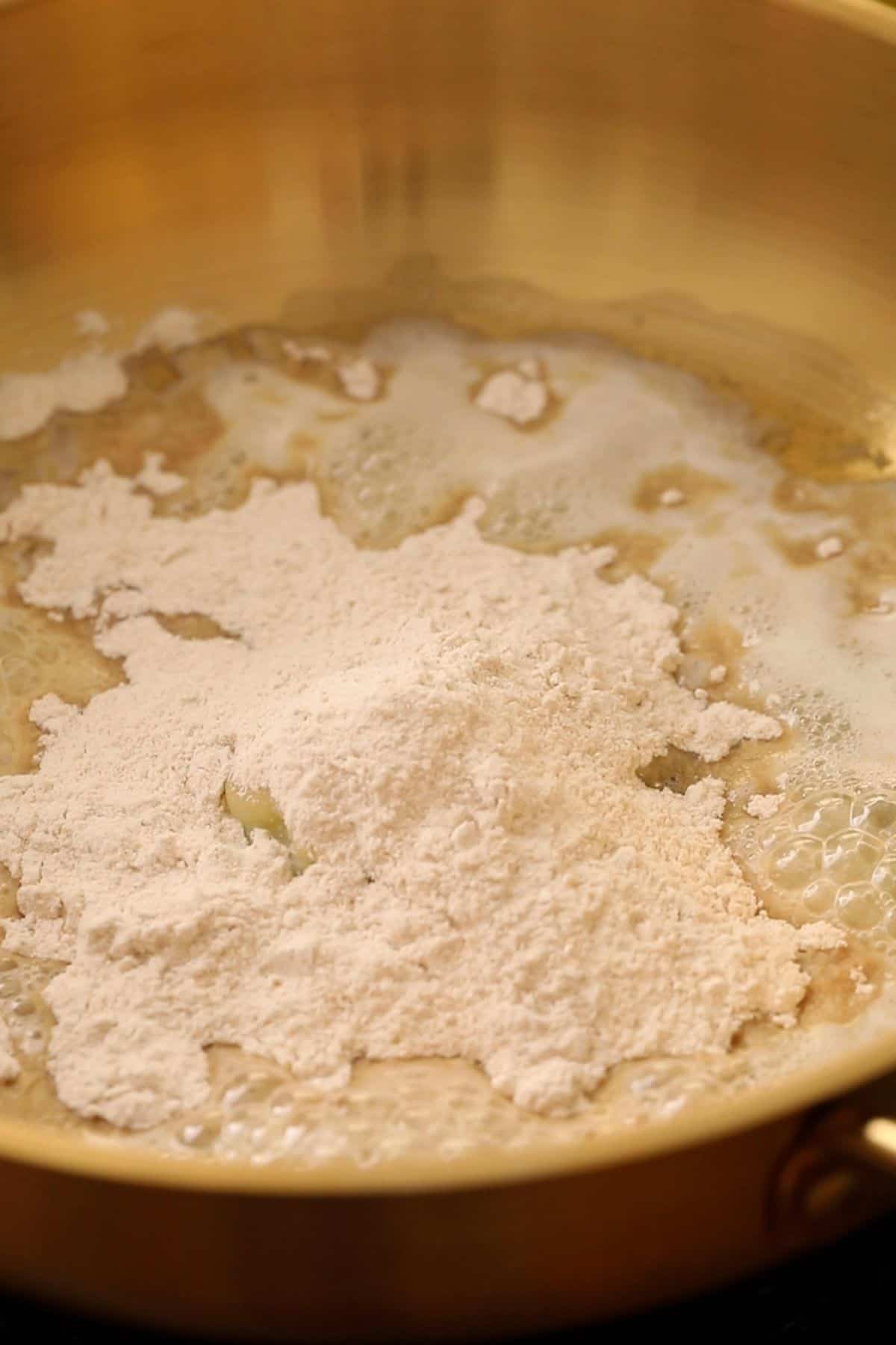 Ghee and wheat flour are added to a kadai.