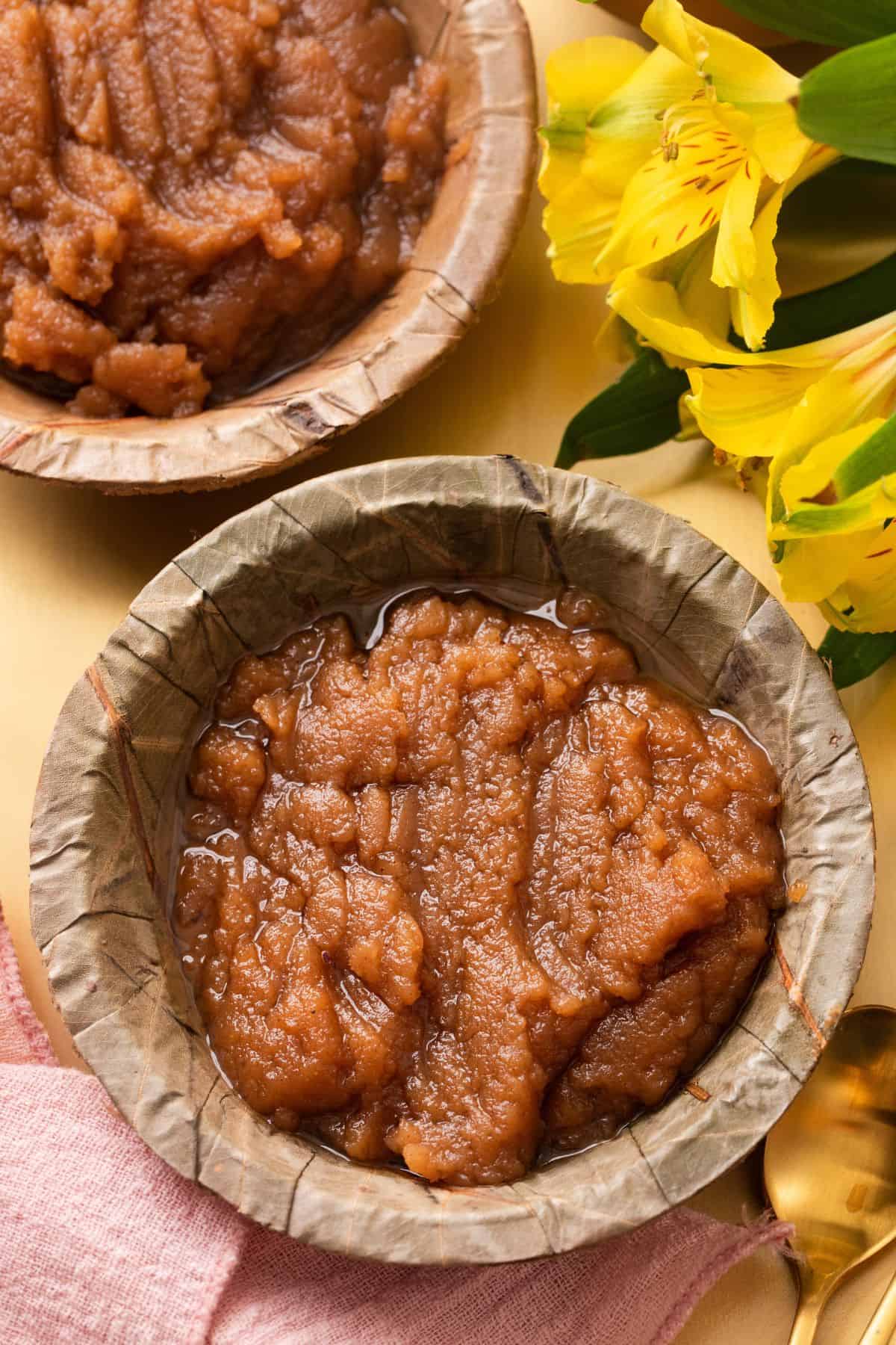 Close up of kada prasad halwa in palm leaf bowls.