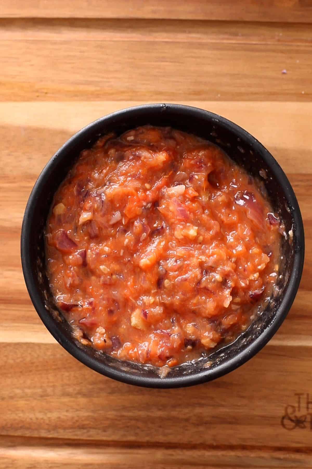 A coarse paste made of charred oniins, tomatoes and garlic.