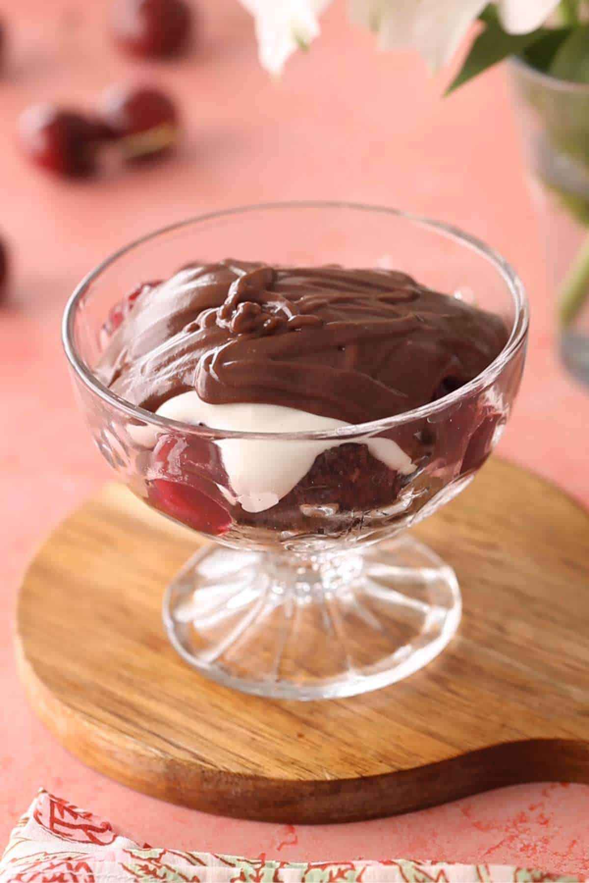 Adding chocolate pudding to the trifle. 