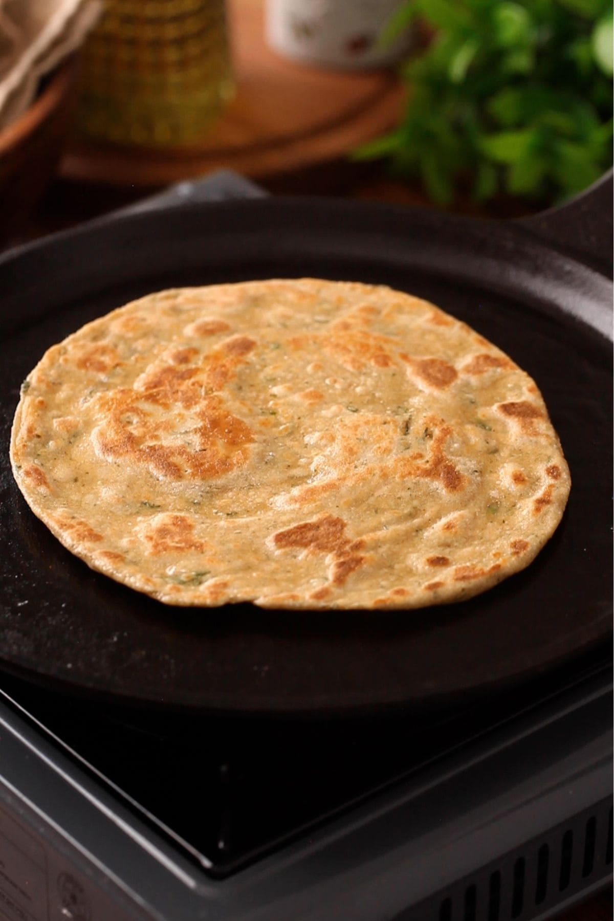Mint paratha is cooked until golden brown.