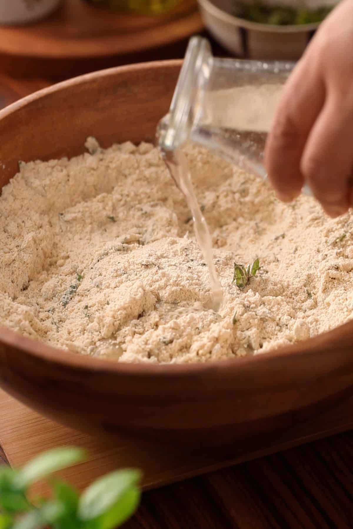 Water is added to the flour mixture to make a soft dough.
