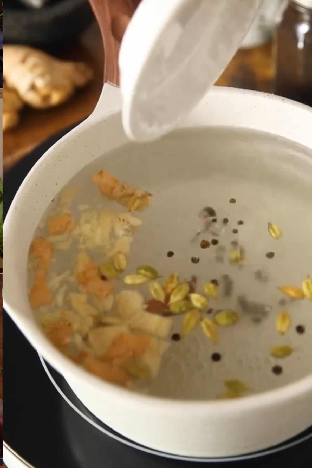 Ginger and Spices are simmering in a large pot of water.