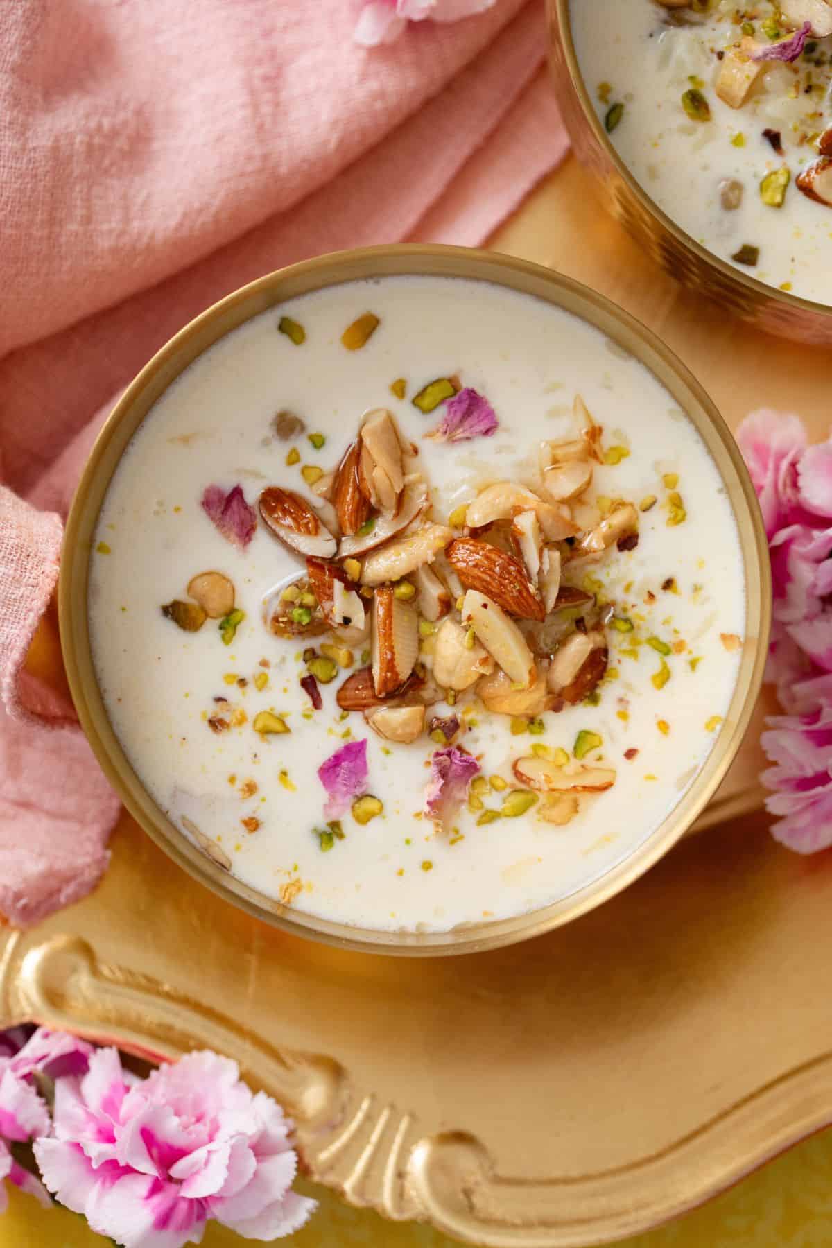 Close up of indian rice pudding in a gold bowl.