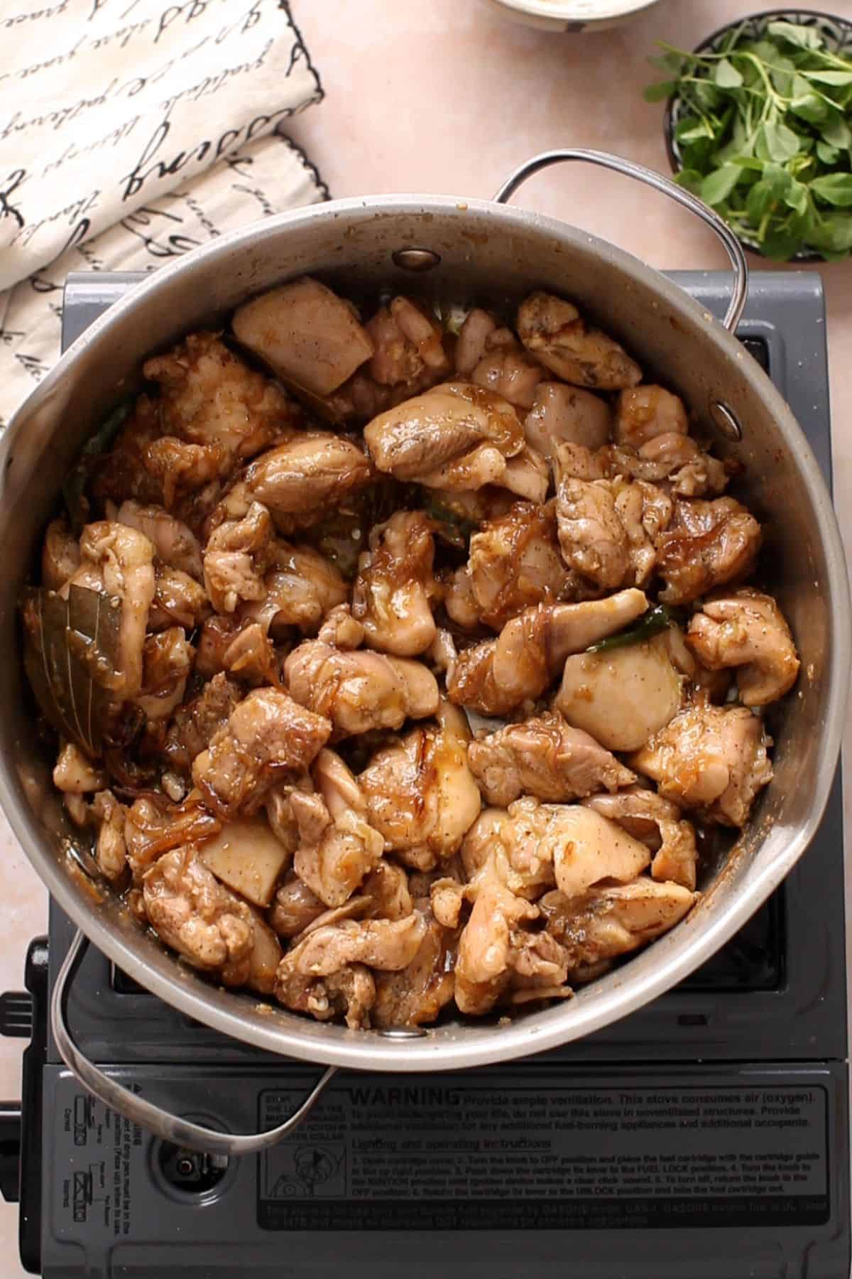 Chicken is browned with the onion and whole spices.