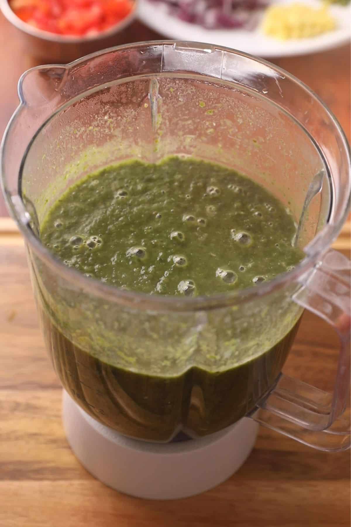 Saag is coarsely pureed in a small blender jar.