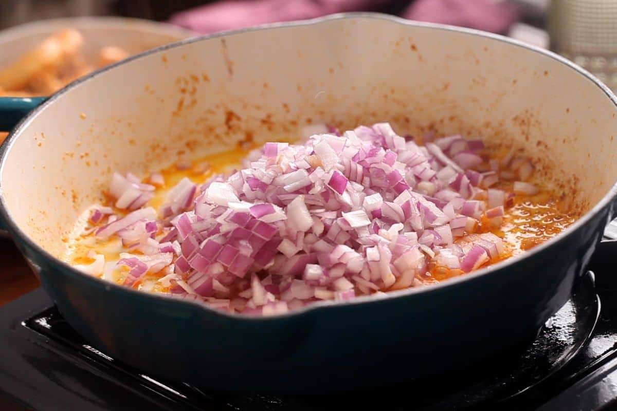 Chopped onion is added to the skillet.