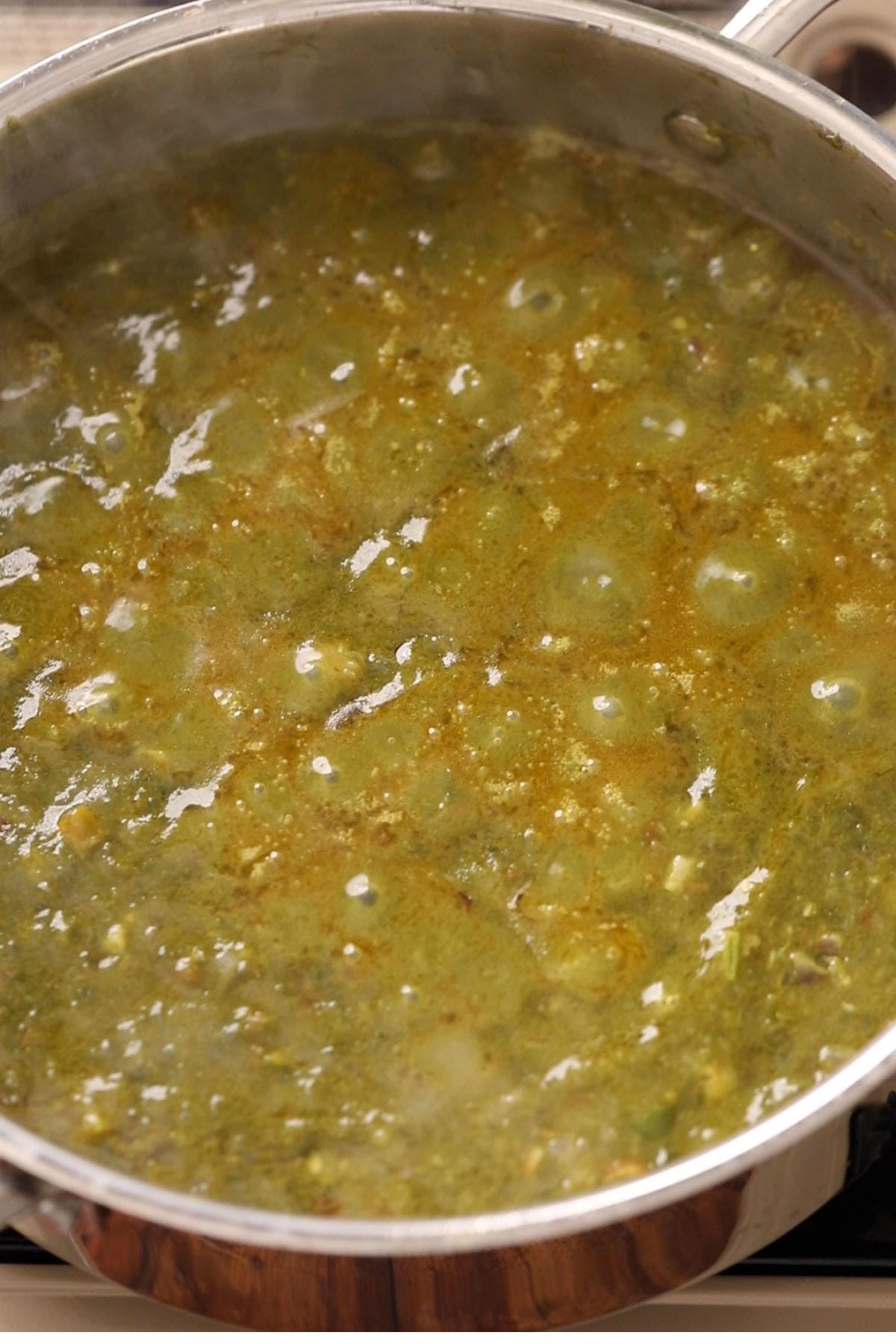 Saag is slow simmered until tiny oil bubbles start appearing on top surface.