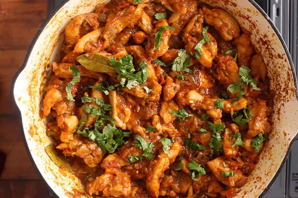 Tawa chicken is garnished with fresh chopped cilantro.