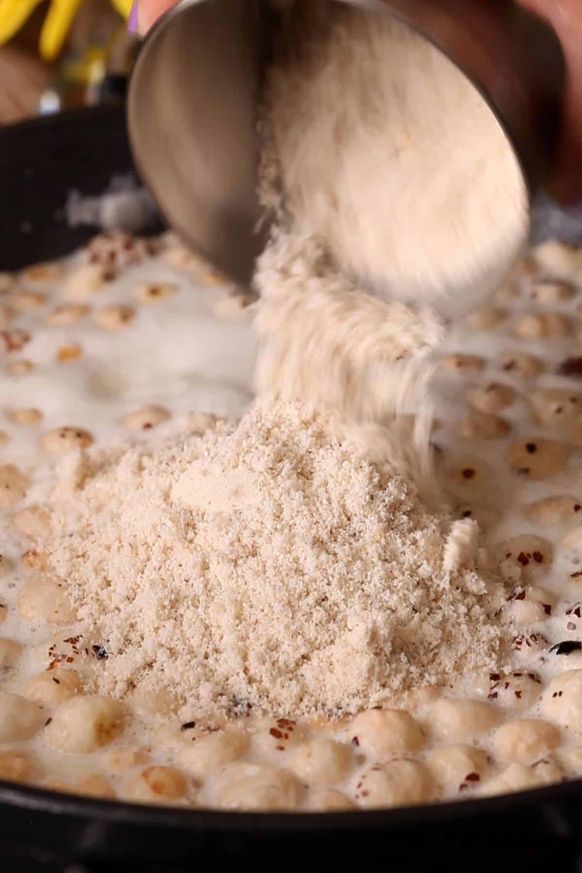 Powdered makhana is added to the simmering kheer.