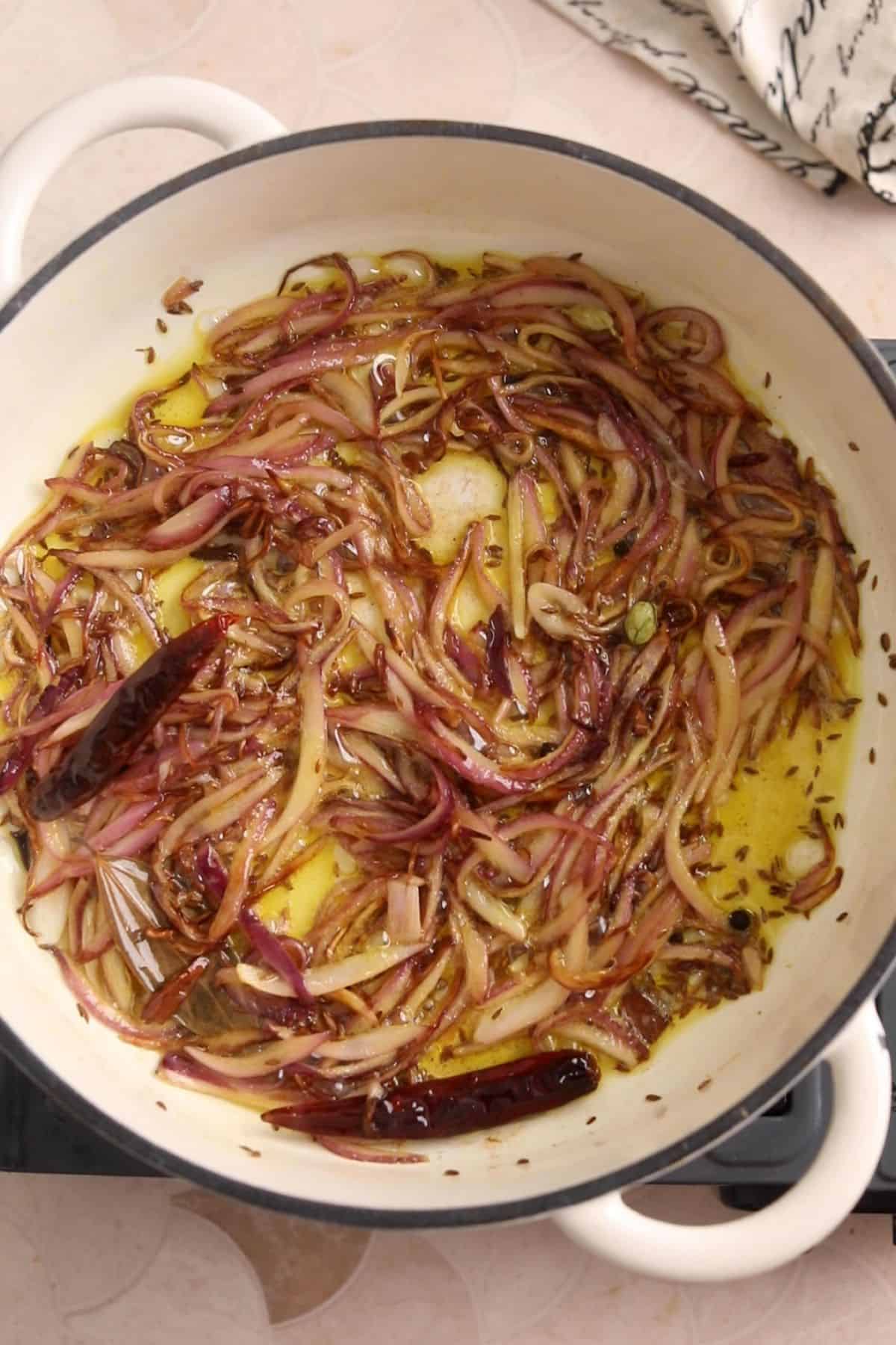 Browned onions in a cooking pot.