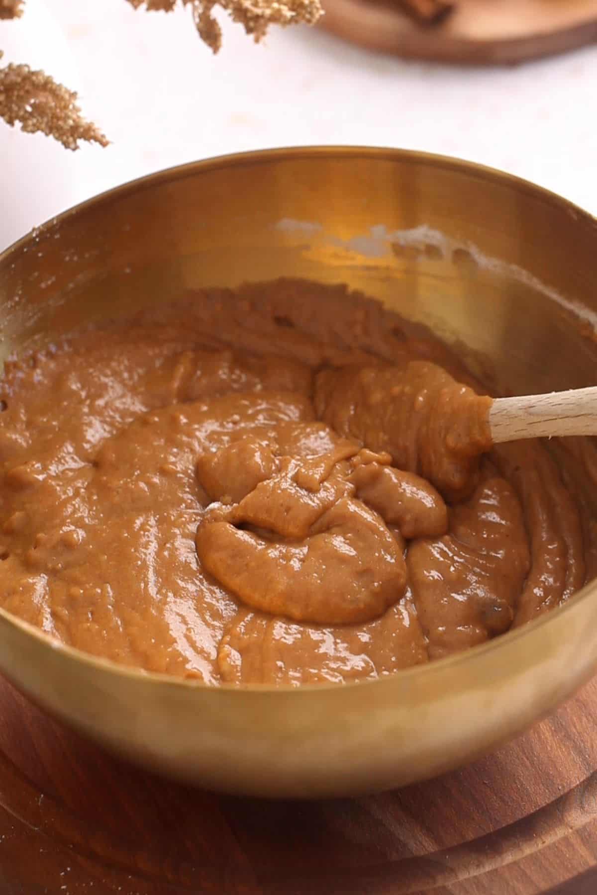 Chai cake batter is mixed with a spatula.