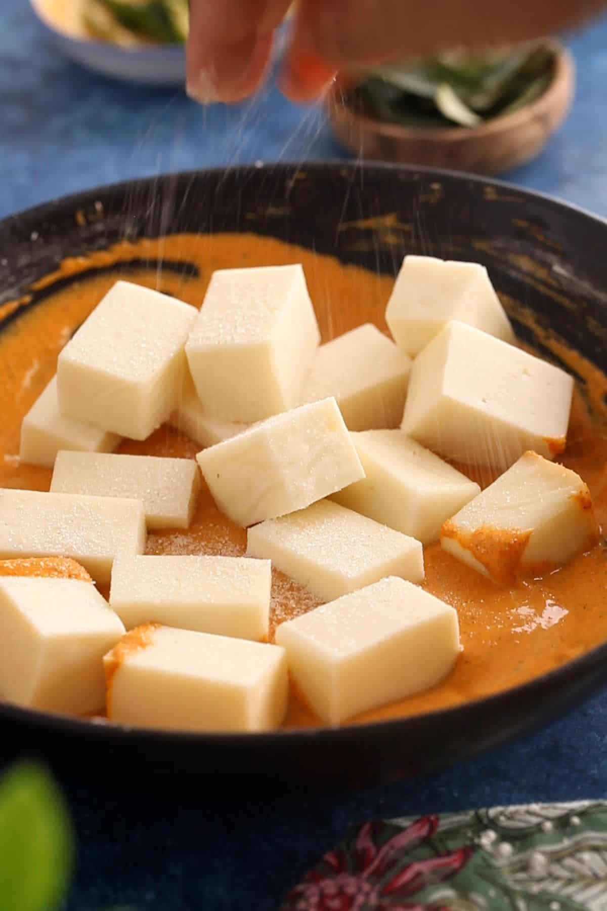 Paneer cubes are added to the spicy batter.
