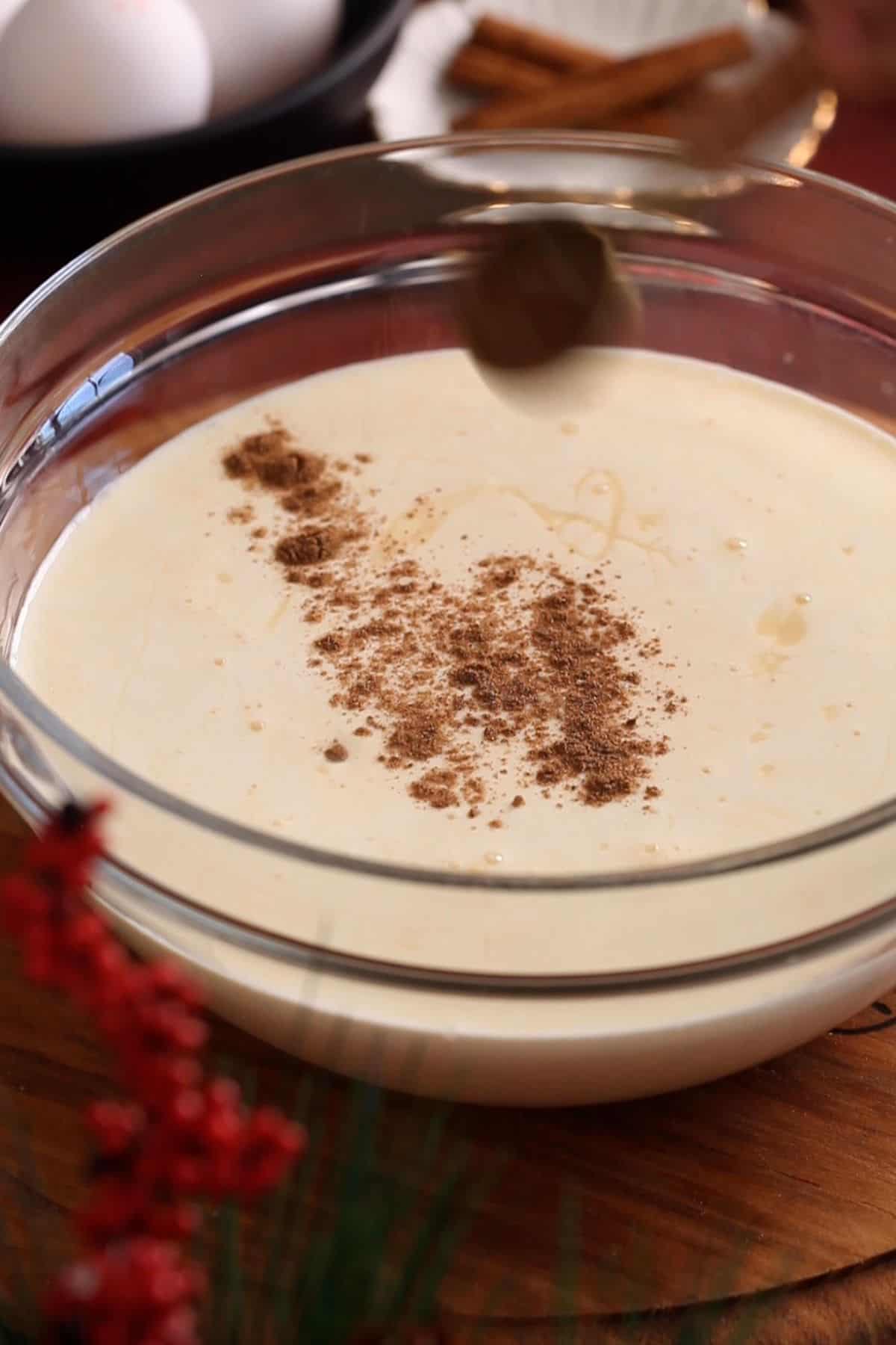 Adding spices to the tres leches mixture.