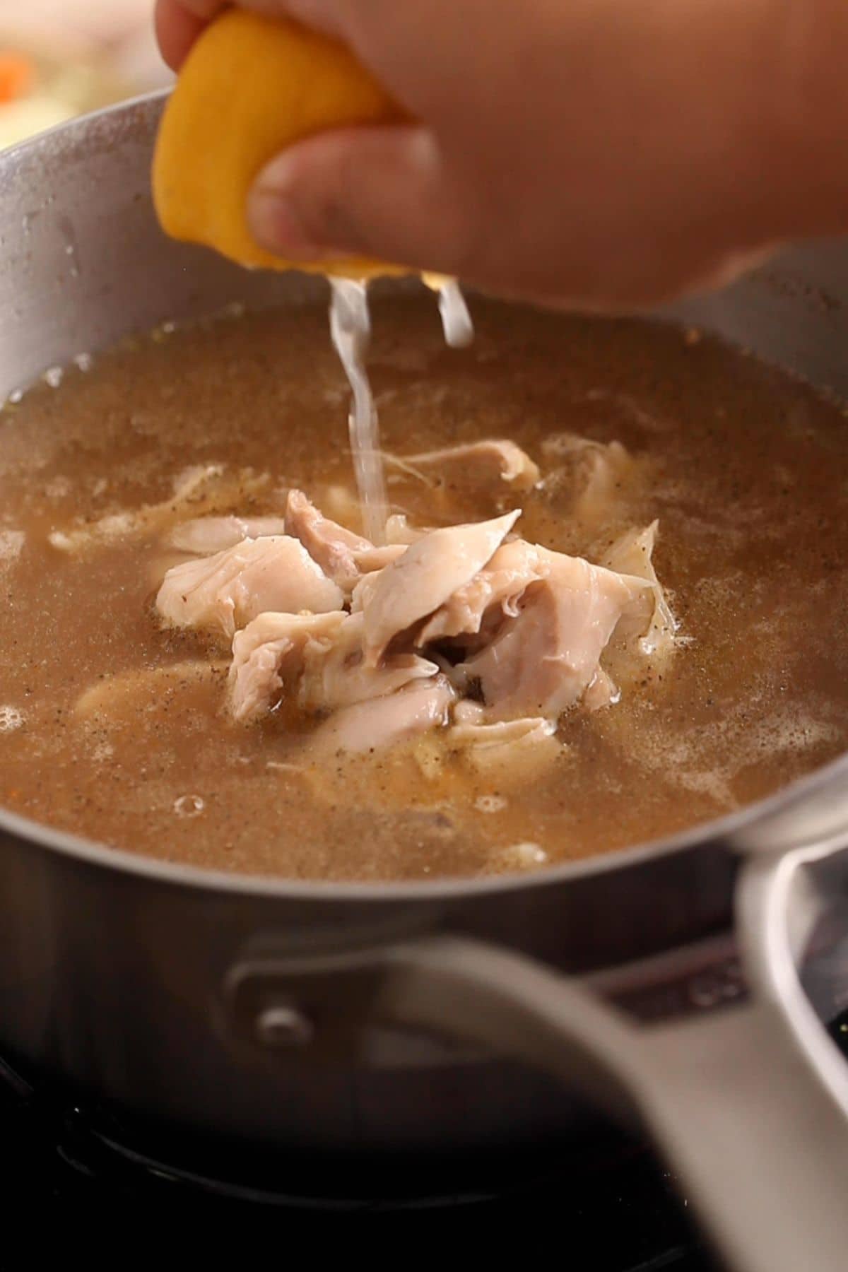 Shredded chicken and lemon juice are added to the broth.