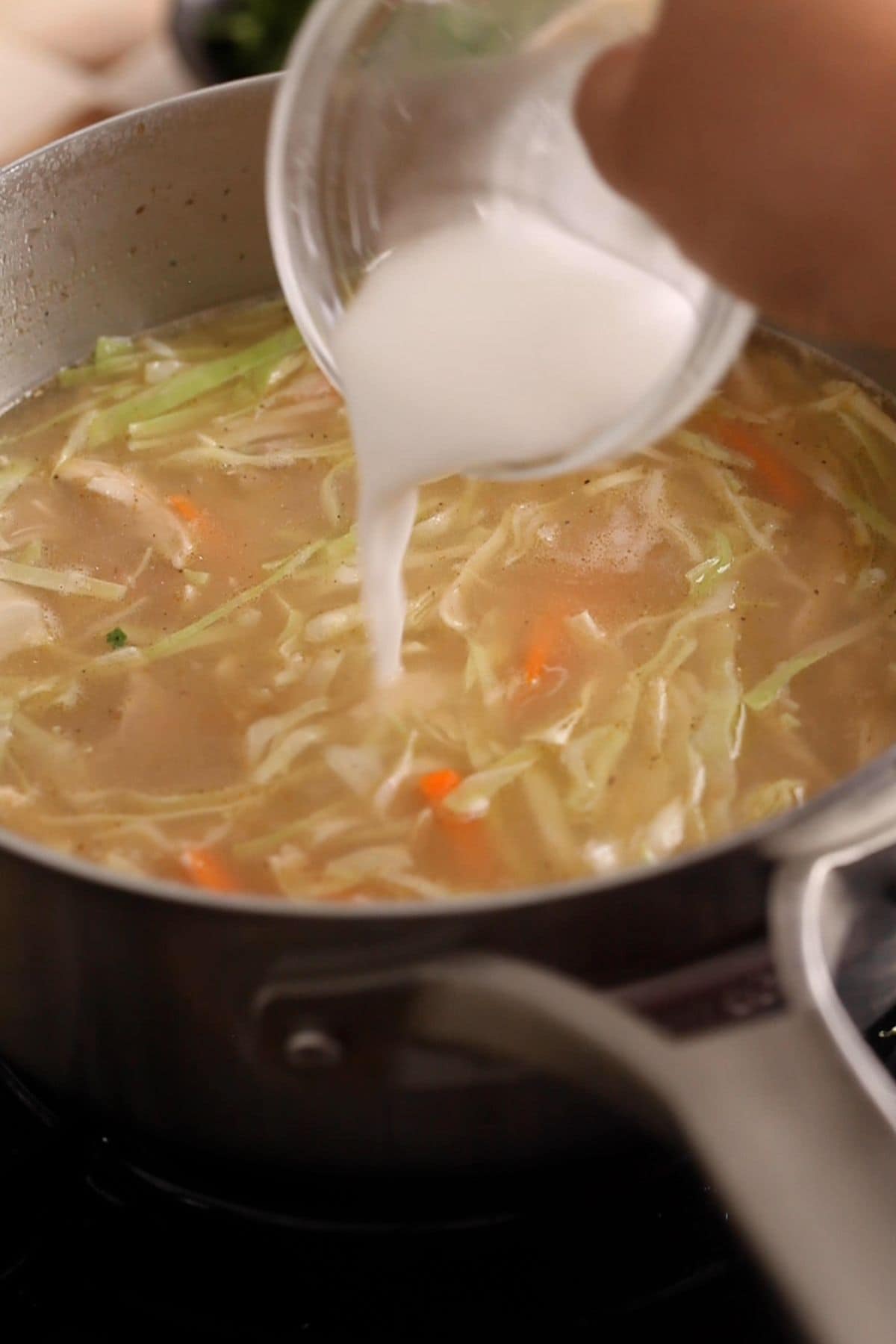 Cornstarch slurry is added to the chicken soup.