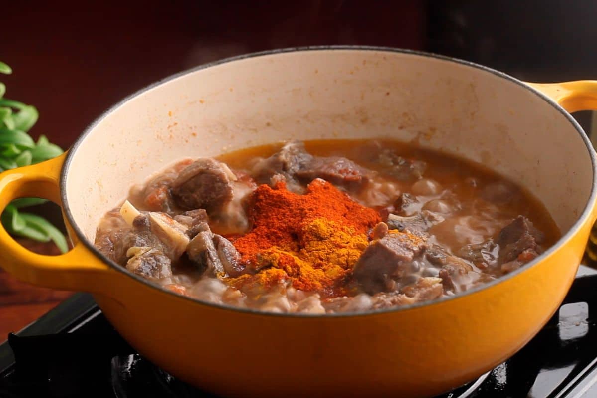 Ground spices are added to the meat.