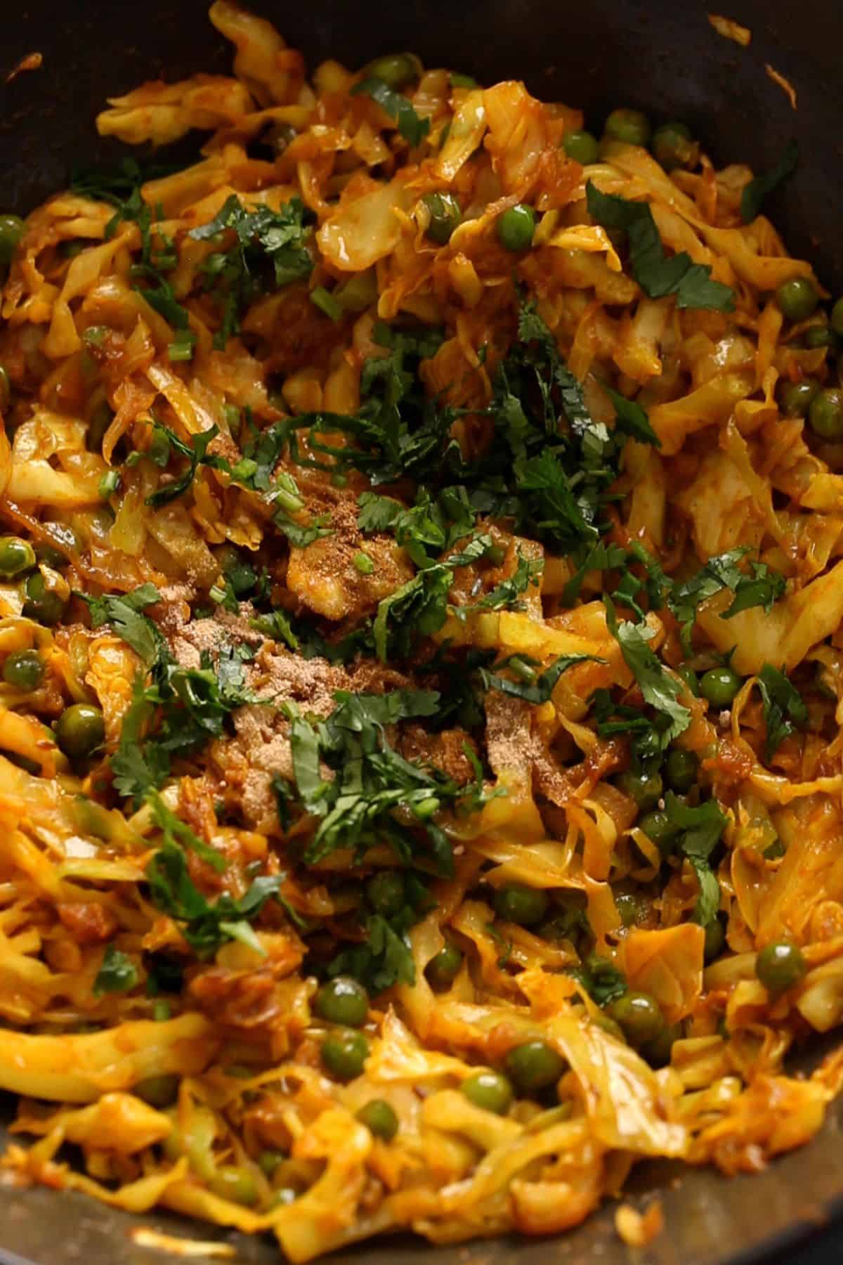 Cabbage sabzi is finished with spices and chopped cilantro.