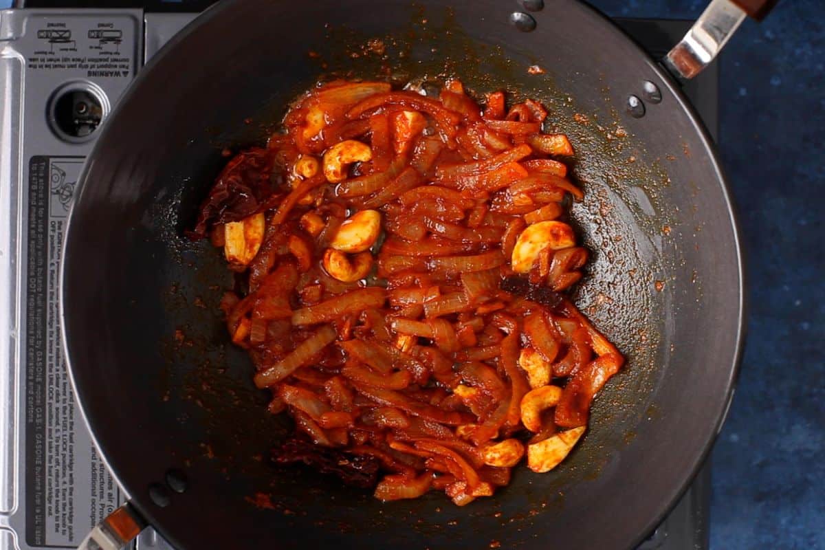 Onions and kashmiri red chili powder are sauteed.
