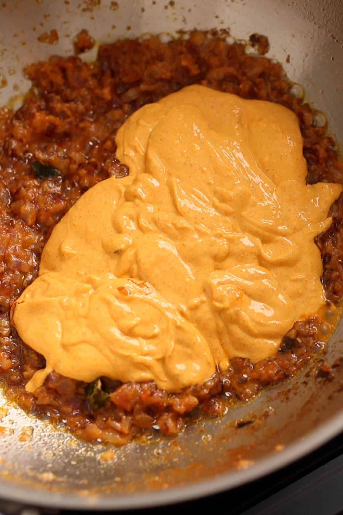 Spiced yogurt mixture is added to the masala.