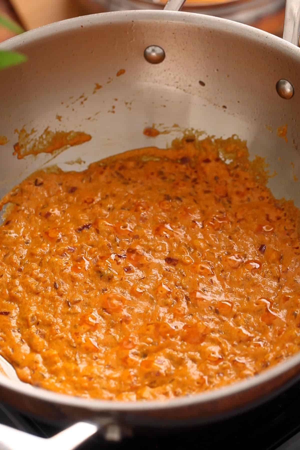 Masala is cooked until small oil bubbles are visible on the surface.