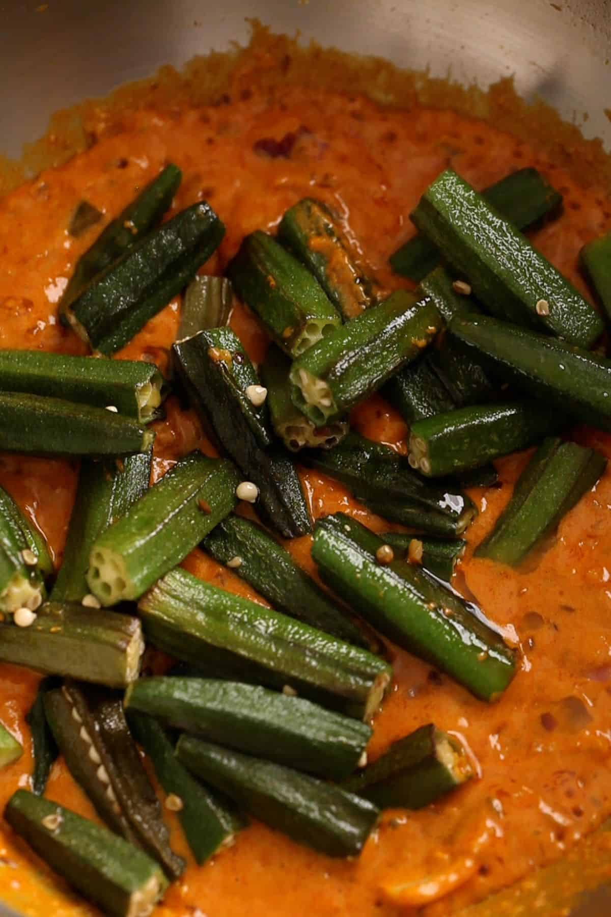 Fried bhindi is added to the cooked masala.