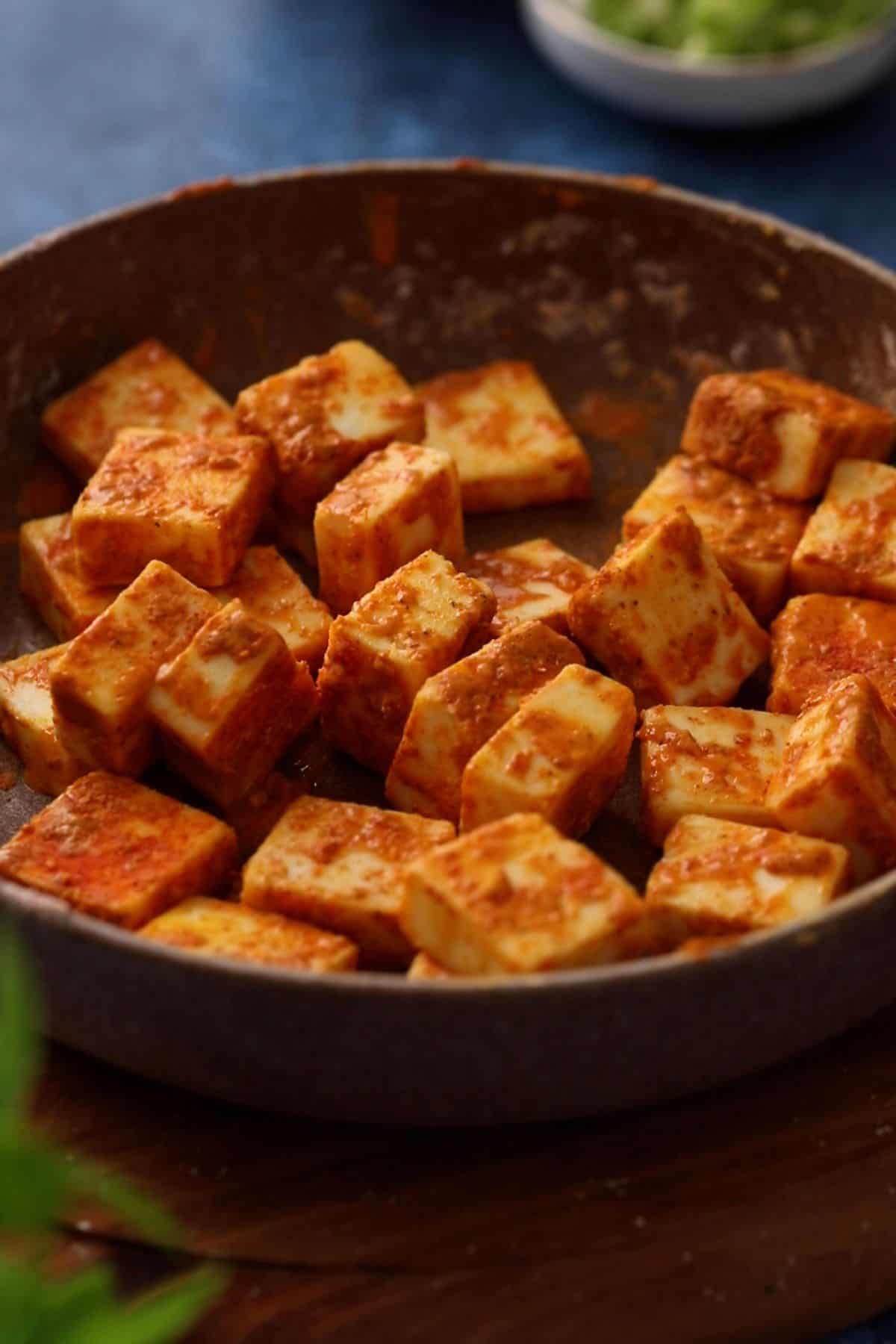 Paneer cubes coated in spices.