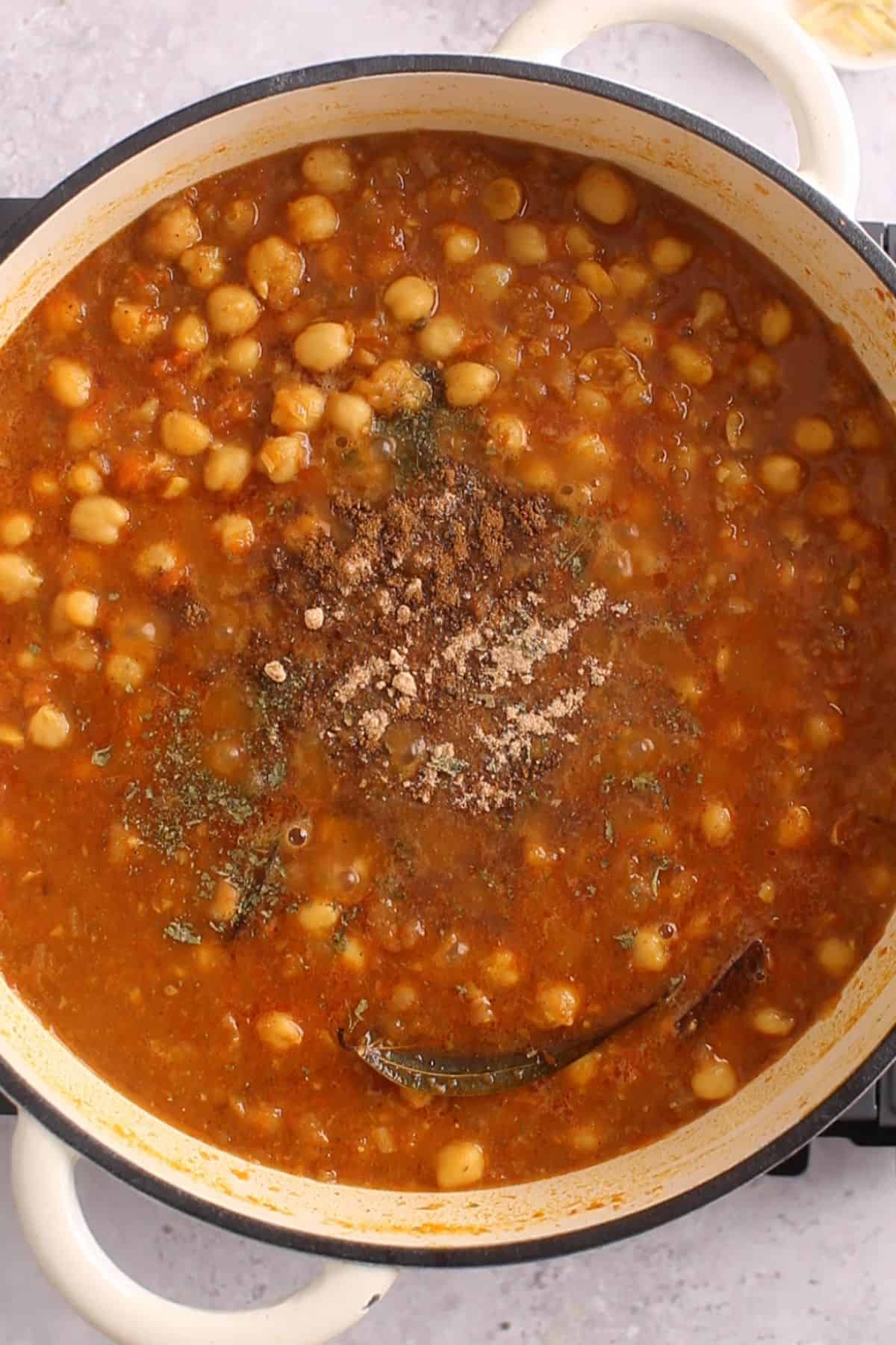 Finishing spices are added to the slow cooked chana masala.