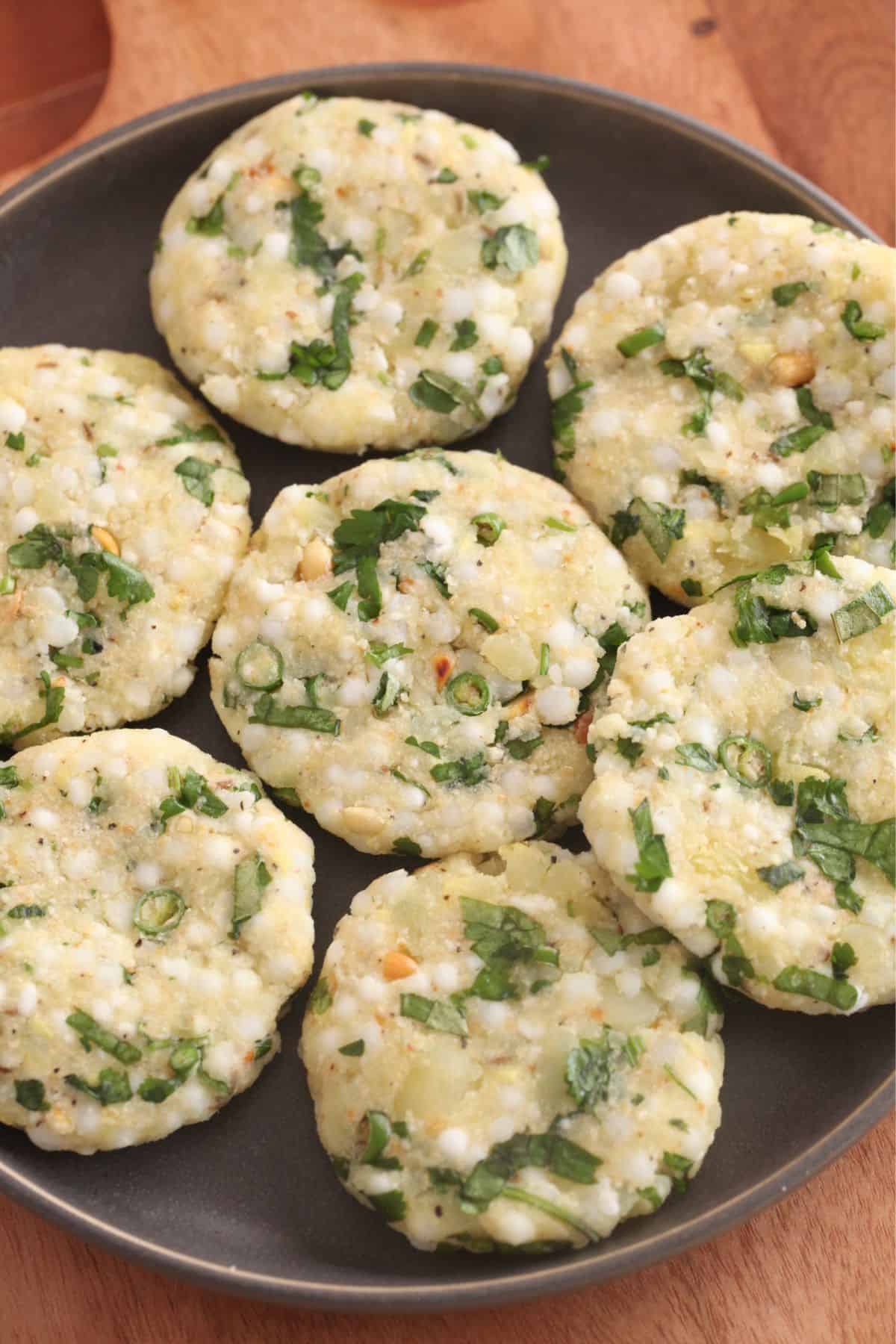 Shaped sabudana patties placed on a grey plate.
