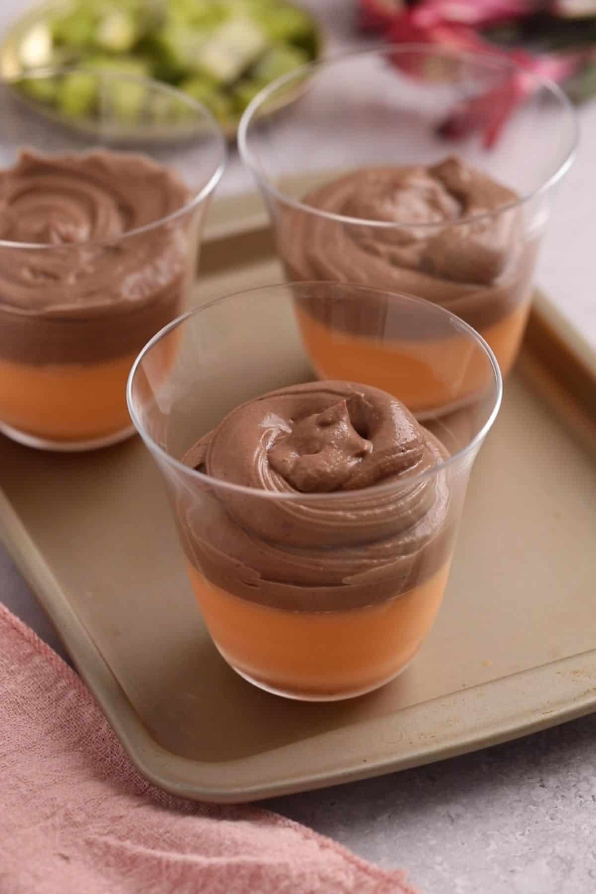 Orange jelly layer is topped with chocolate shrikhand layer.