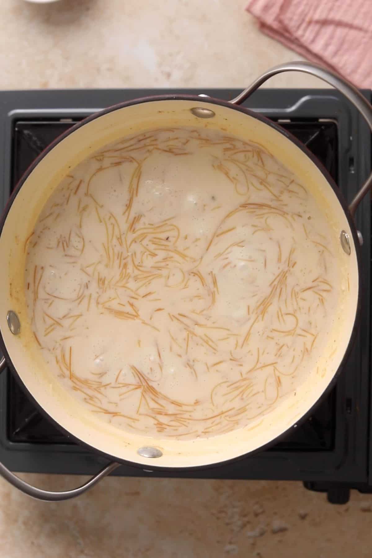 Indian Seviyan Recipe (Creamy Vermicelli Kheer ) 19 Sweet vermicelli kheer is seimmering and thickening on stove.