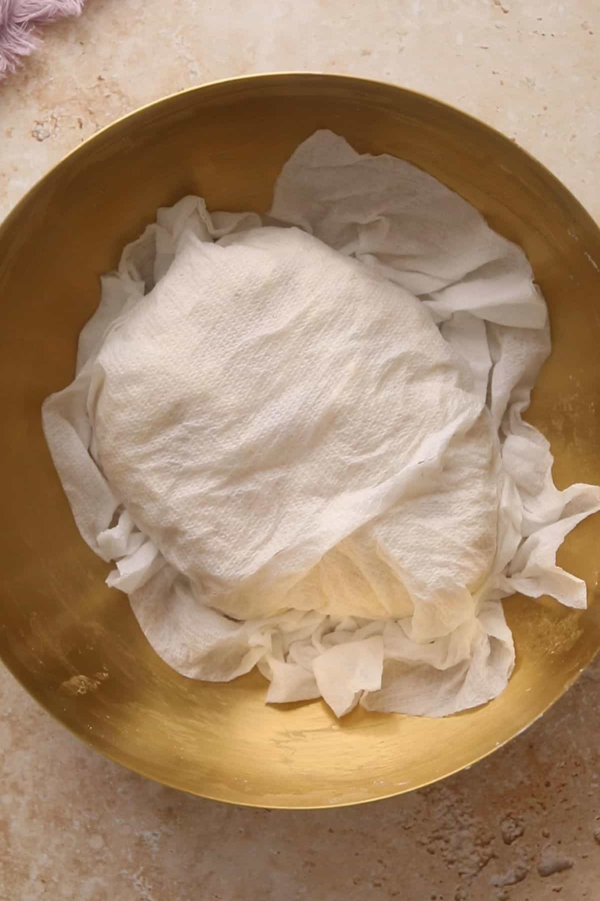 Samosa dough is covered with a damp cheesecloth.