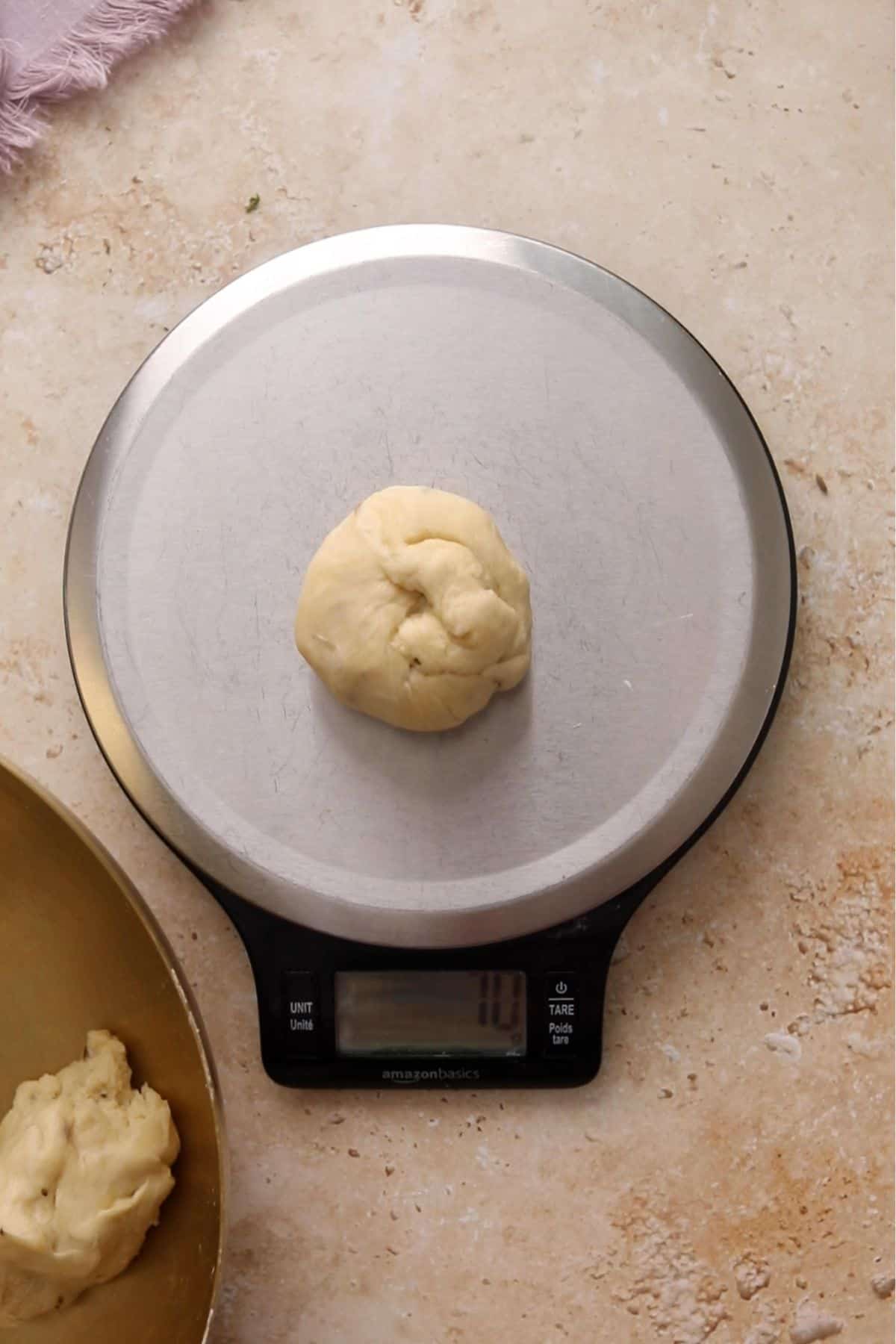 Weighing dough portions on a food scale.