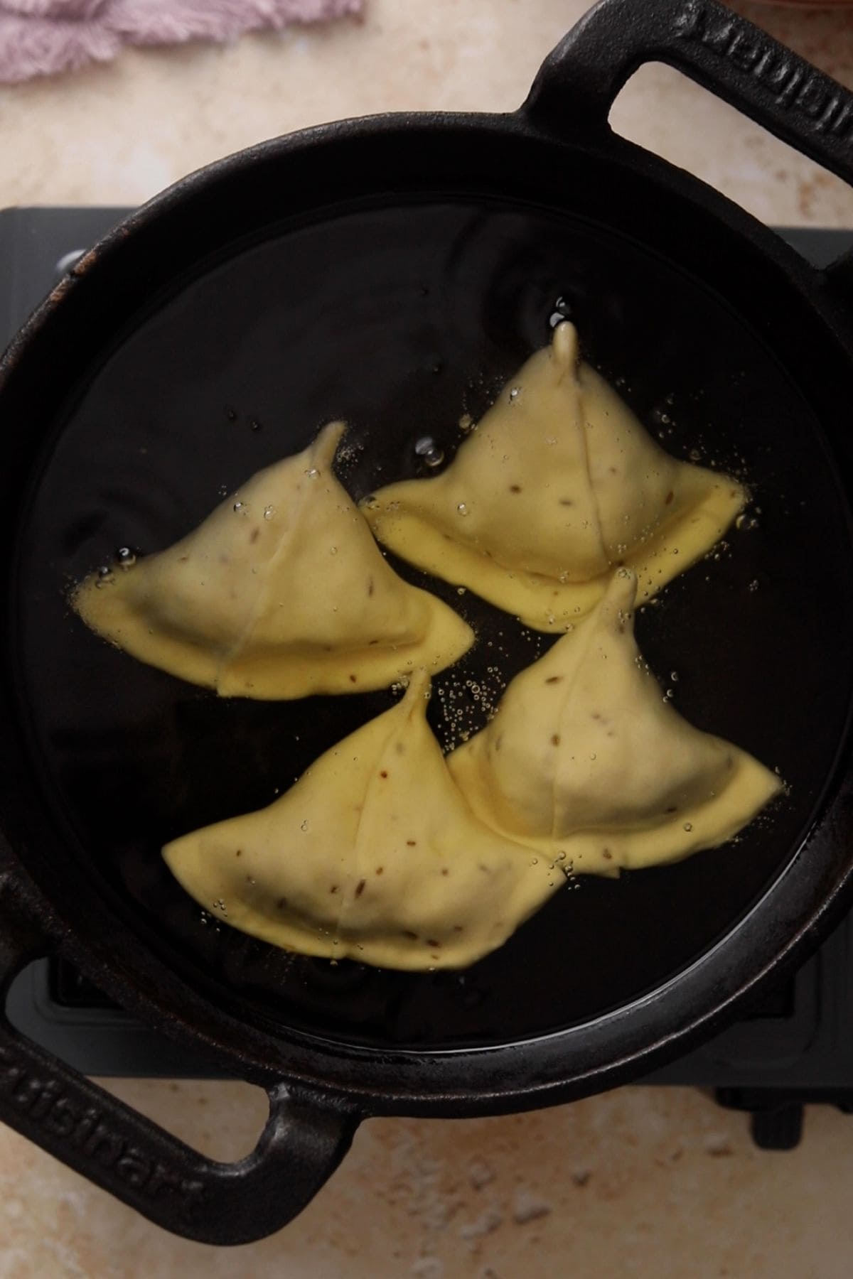 Shaped samosa are added to a oil on very low heat.