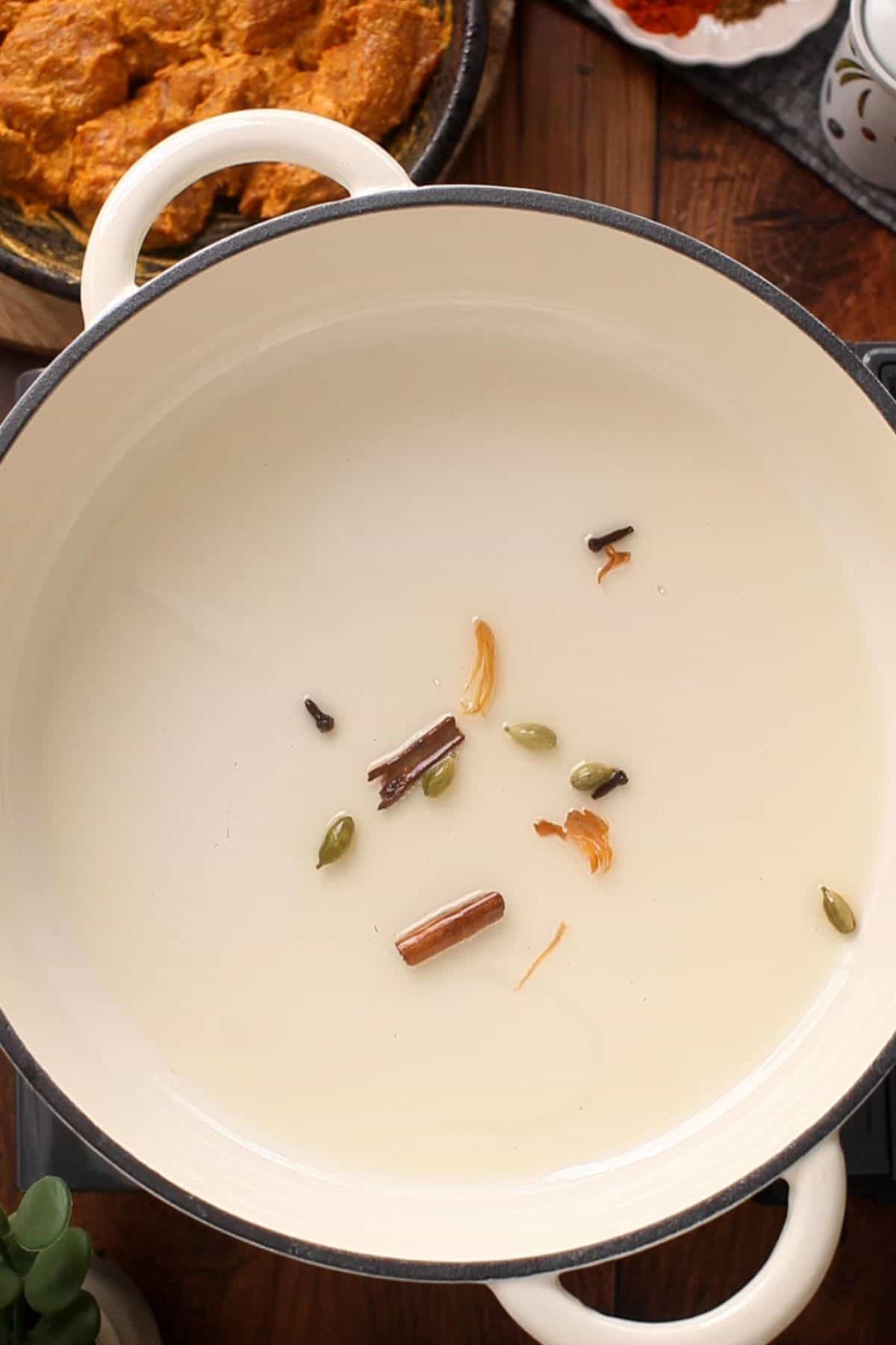 Restaurant-Style Lamb Korma (Rich & Creamy) 12 Whole spices are spluttering in oil.