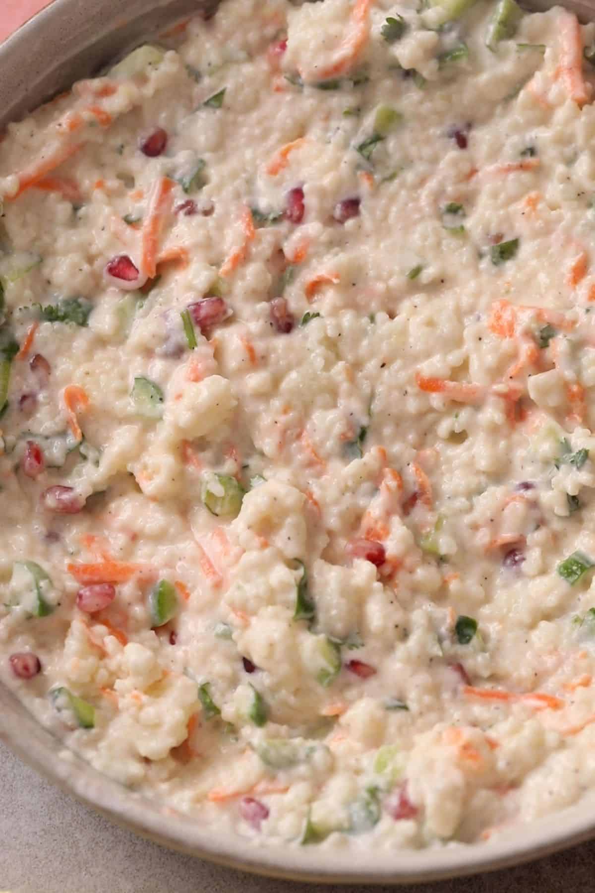 Curd Rice With Millets (Fasting Friendly) 11 Mixed up samo rice in a white stone bowl.