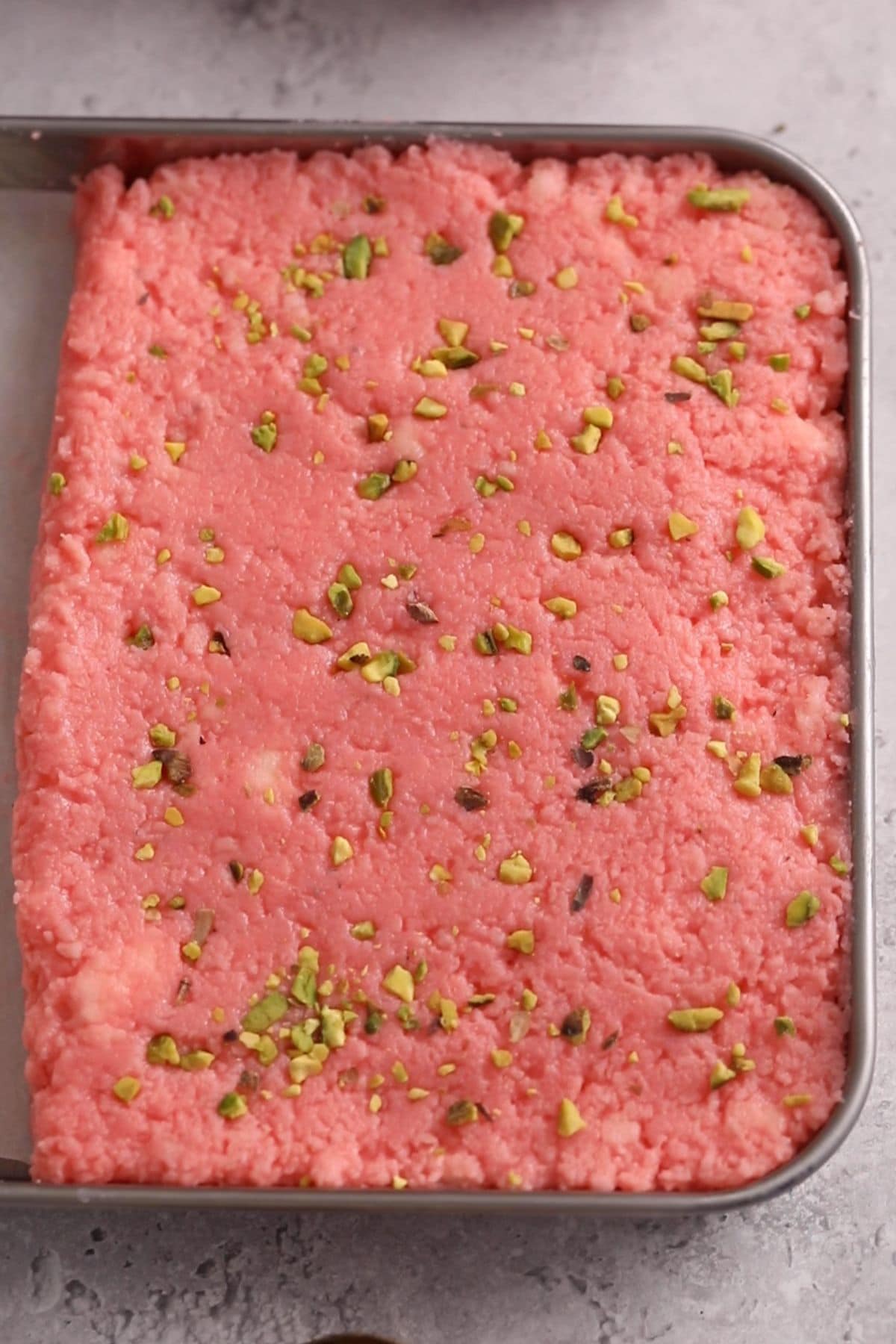 Rose Kalakand Recipe (With Paneer) 17 Kalakand mixture is set in a tray.