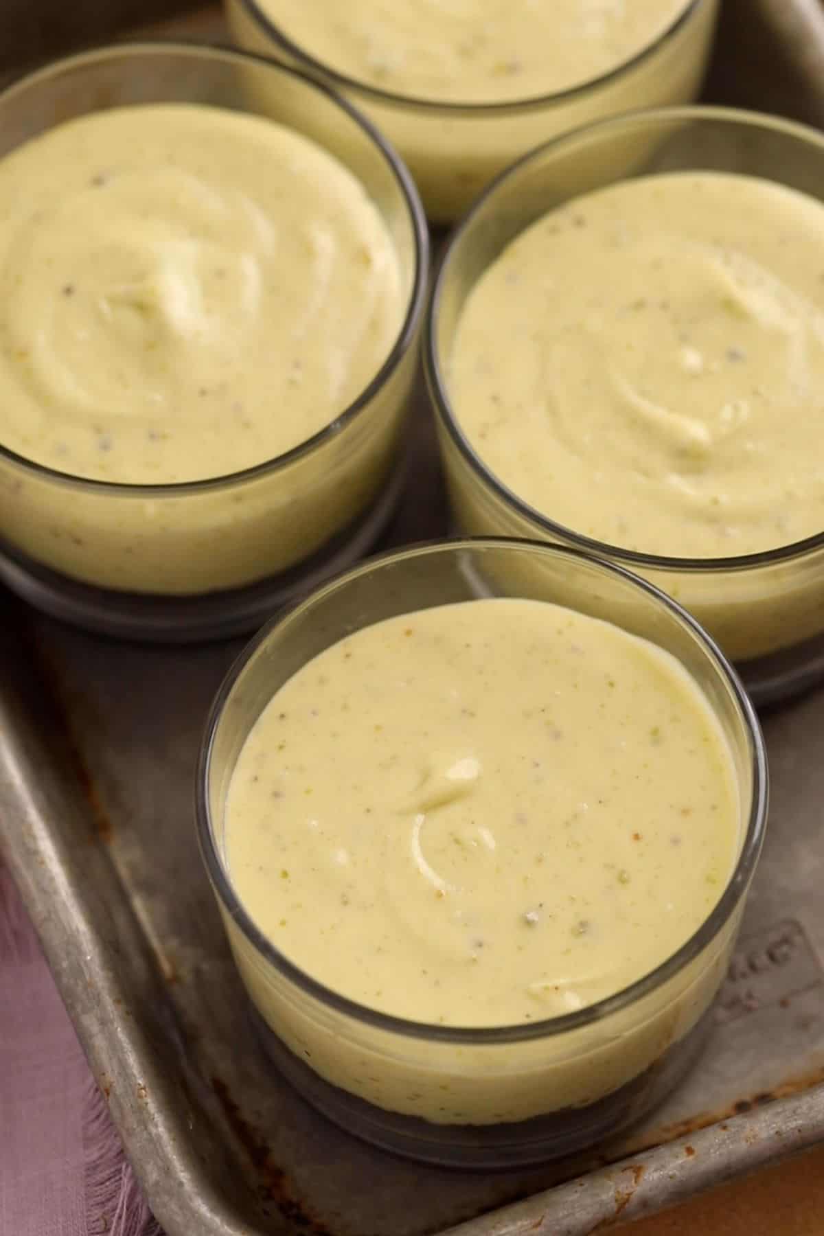 No Bake Pistachio Cheesecake Cups 21 Pistachio ceesecake cups are placed in a tray to chill.