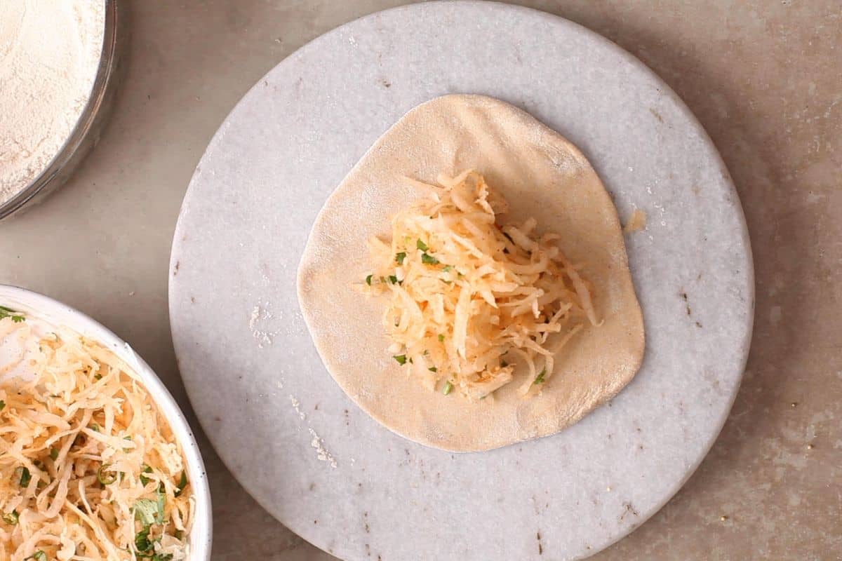 Punjabi Mooli Paratha (Stuffed Radish Paratha) 11 Mooli stuffing is placed on the rolled dough.